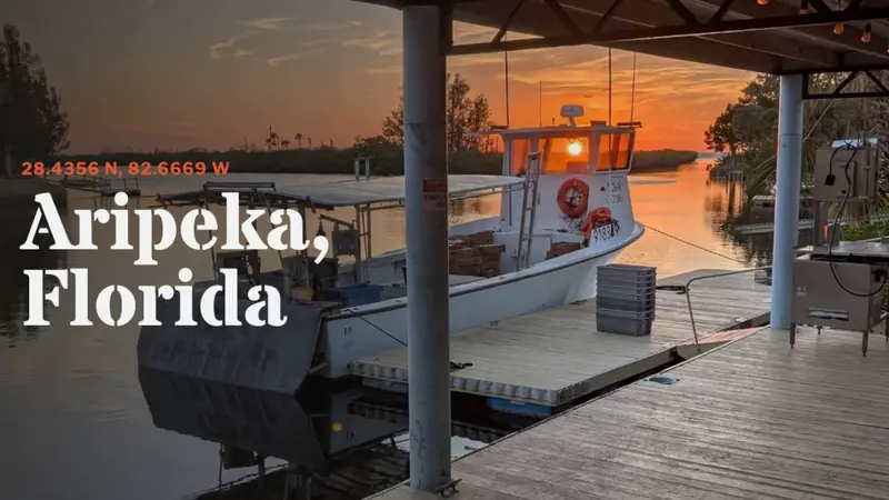 Opening frame of our film: our boat at the dock at sunset, titled Aripeka, Florida